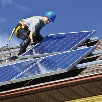 Arbeiter auf Dach mit Photovoltaikanlage