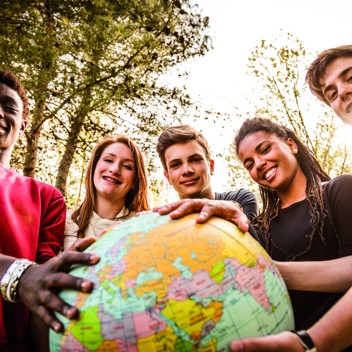 Jugendliche halten einen Globus