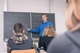 Lehrer vor einer Tafel im Unterricht